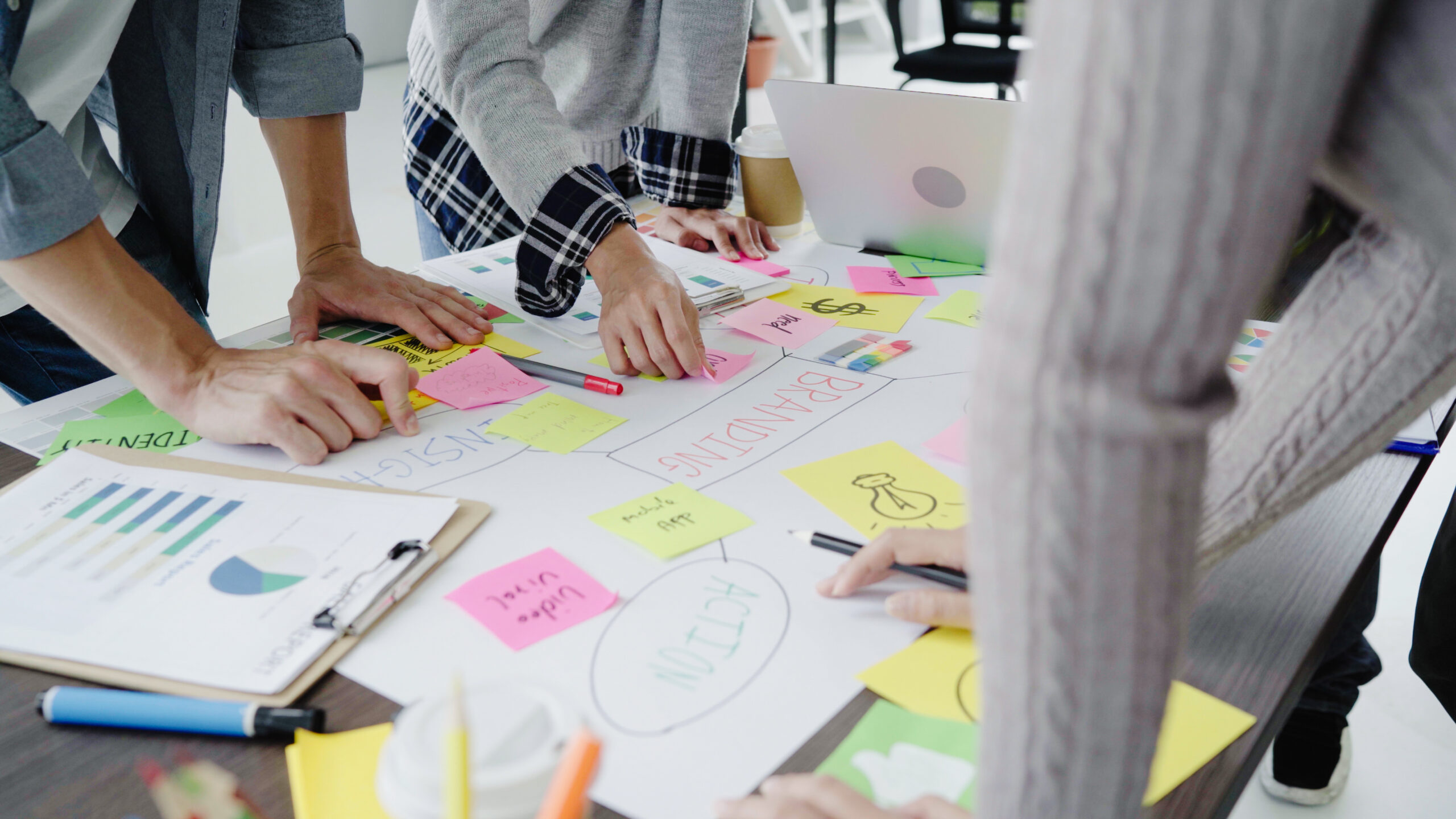 Group of casually dressed business people discussing ideas in the office. Creative professionals gathered at the meeting table for discuss the important issues of the new successful startup project.